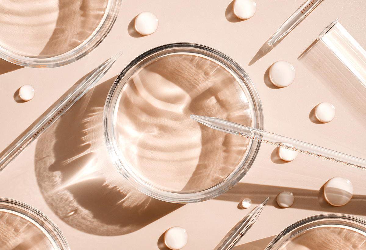 serum in petri dishes on light pink background cosmetic research